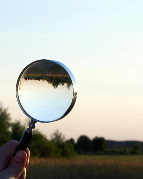 there is a person holding a magnifying glass