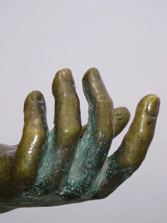 a close up of a bronze statue of two hands