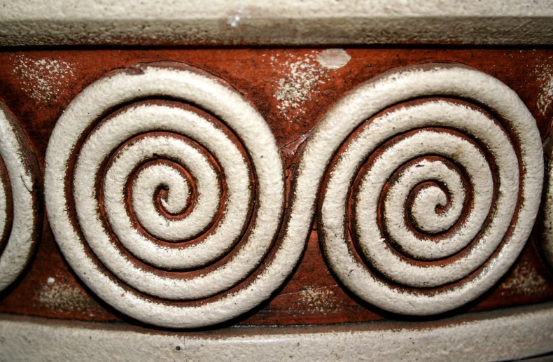 a group of white spiral decorations on the wall