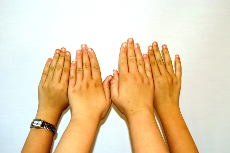 a group of hands are shown on a white surface