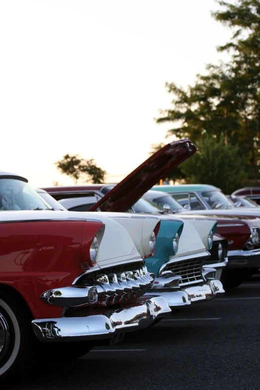 an old fashioned car sits parked on the road