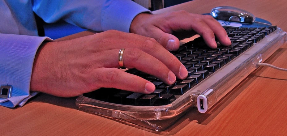 a person using a computer keyboard on a desk