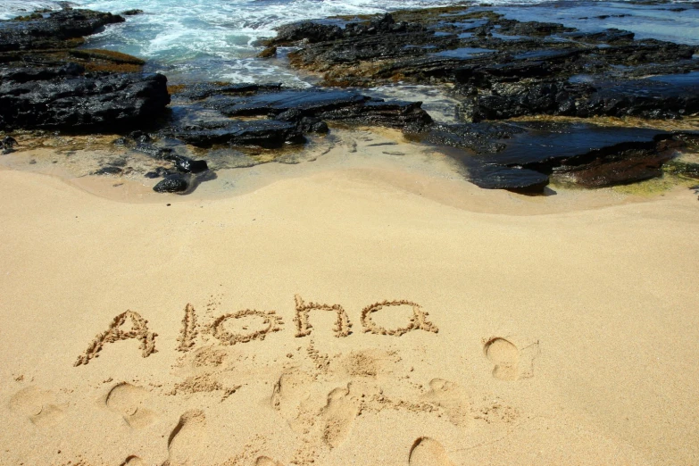 someone wrote the word alamc on the beach
