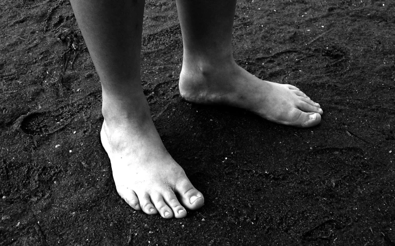 a person is standing in the sand with their toes