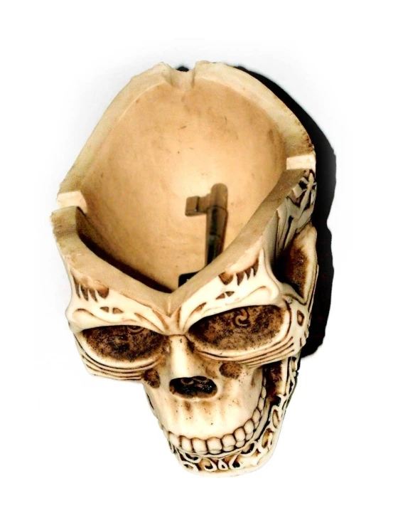 an old wooden mask has a cross on its head