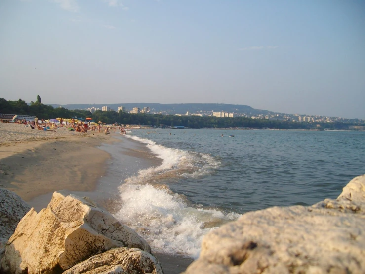 water, sand, and rocks on the beach near the shore