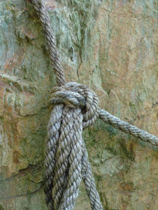 a rope wrapped around the edge of a cliff face