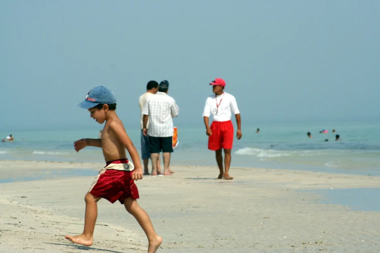 the young child in shorts is playing with a frisbee