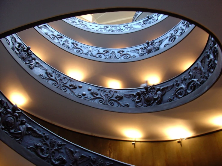 an artistic staircase is lit up with dim lighting