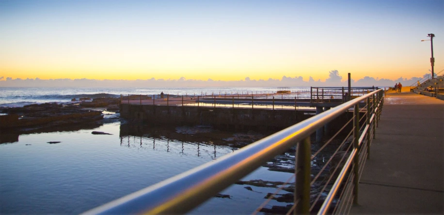 a very large metal railing overlooking a body of water