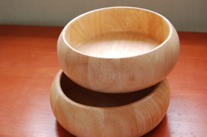 a close up view of two bowls on a wooden table