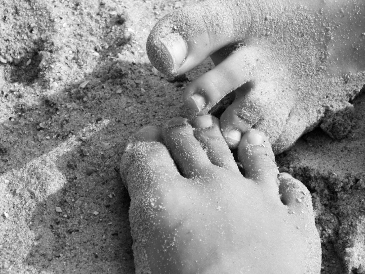 black and white po of person playing in the sand