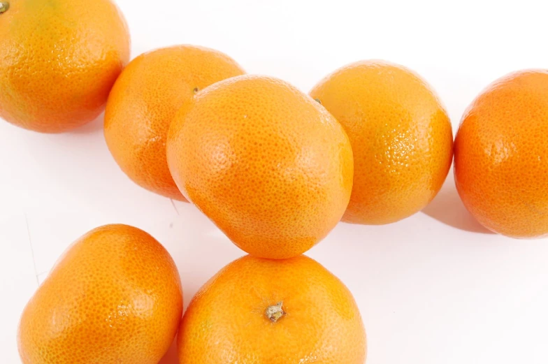 a group of oranges on top of each other on a table