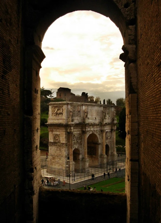 a view of a roman amphit through a stone arch