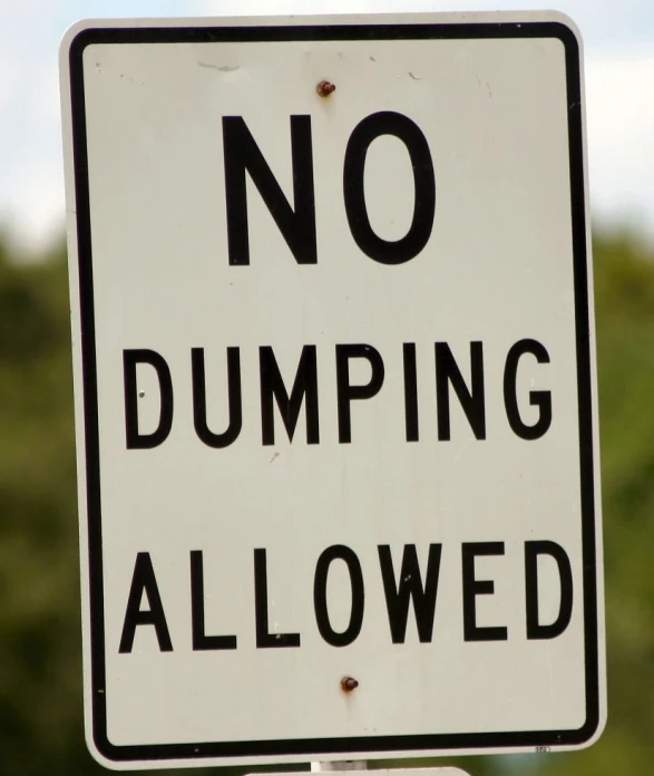 a street sign stating no dumping allowed