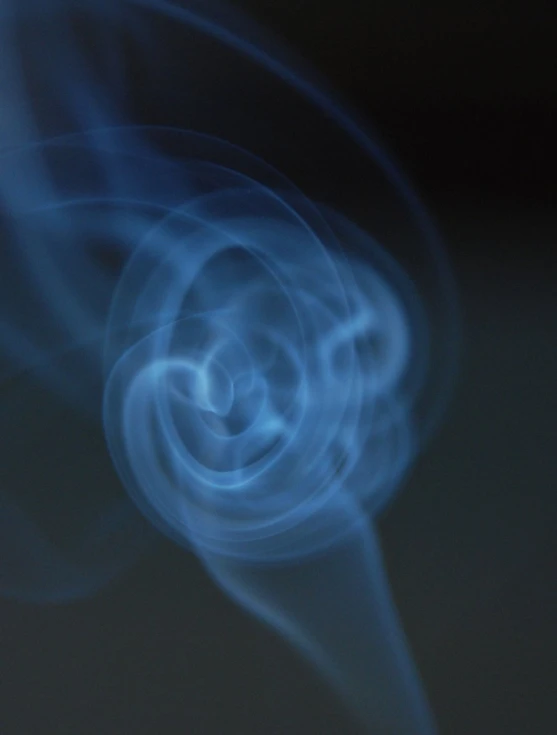 blurry pograph of a blue smoke in the dark