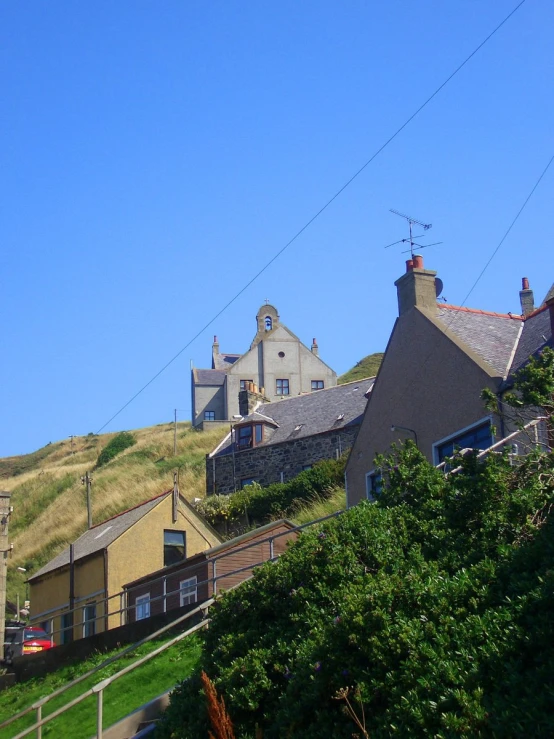 a house that is sitting next to a hill