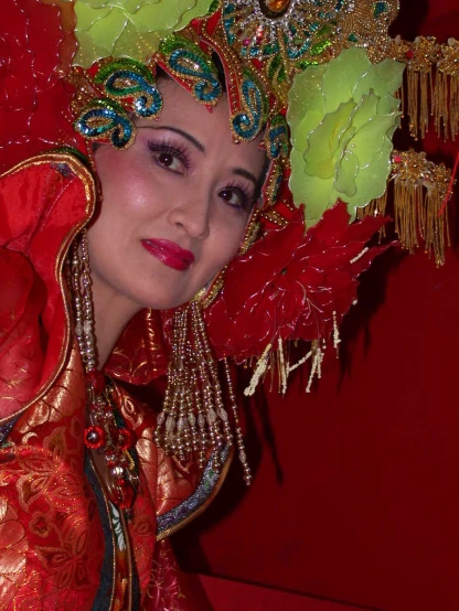 a woman with a chinese headpiece wearing elaborate clothing