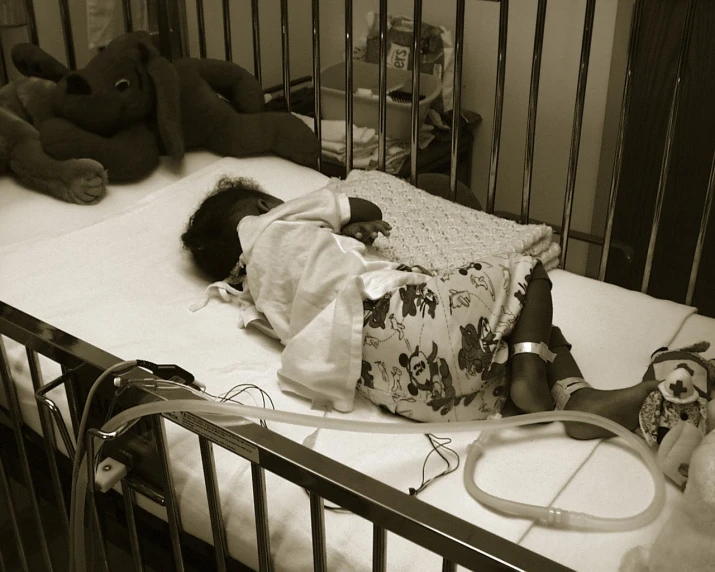 an african baby girl laying down on a crib