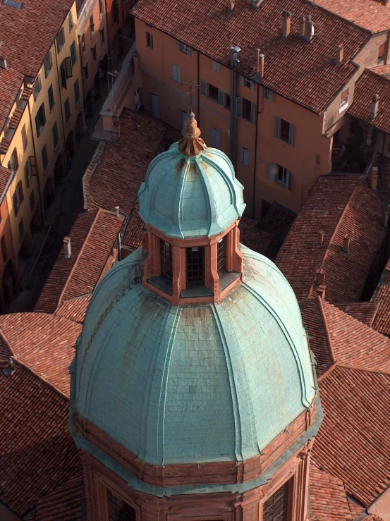 a large building with a green roof is viewed from above