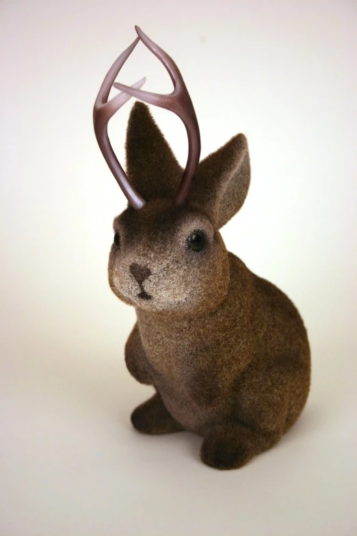 a stuffed rabbit with a weird looking face sitting down