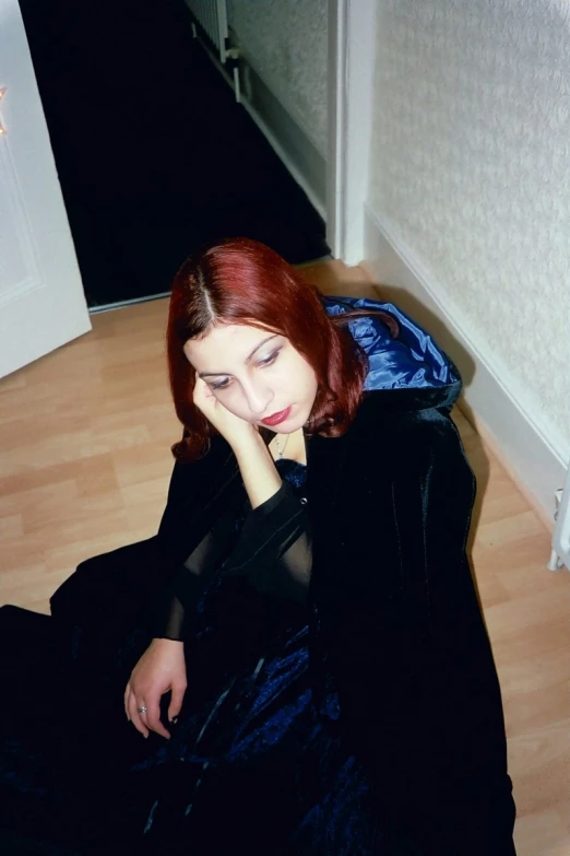 an image of a woman sitting on the floor posing for a po