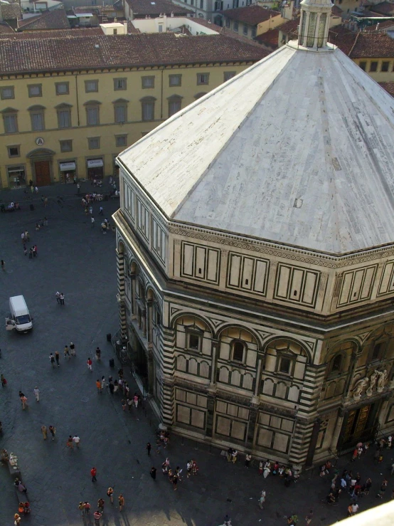 an aerial view of a group of people gathered around a building