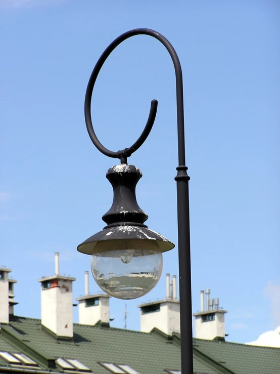 a lamp post on the corner of the street