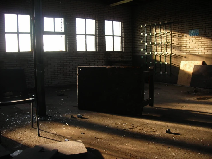 a dilapidated room with broken glass is pictured