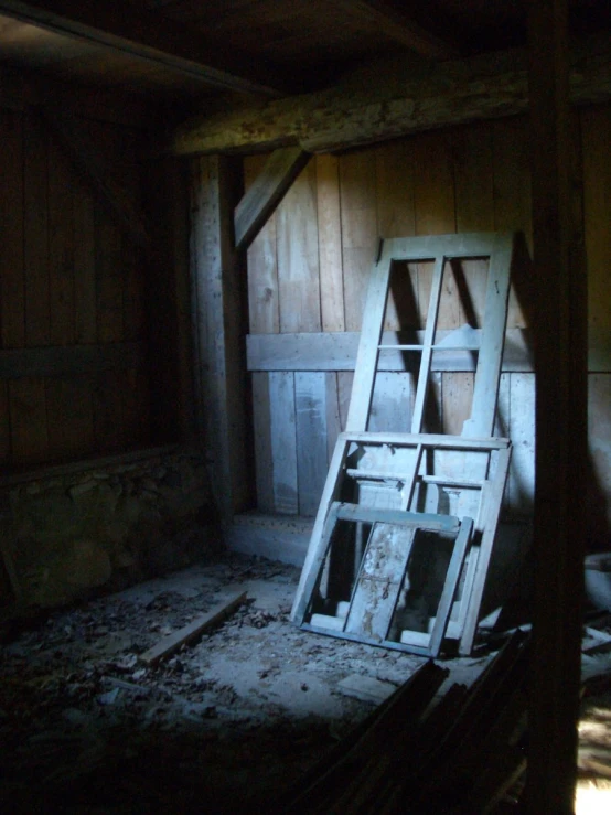 a ladder standing up against a wooden wall