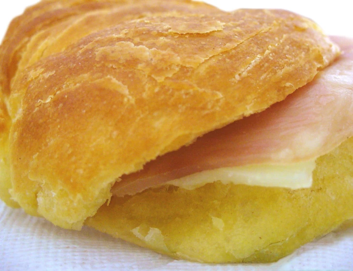 a close up of bread with ham and cheese