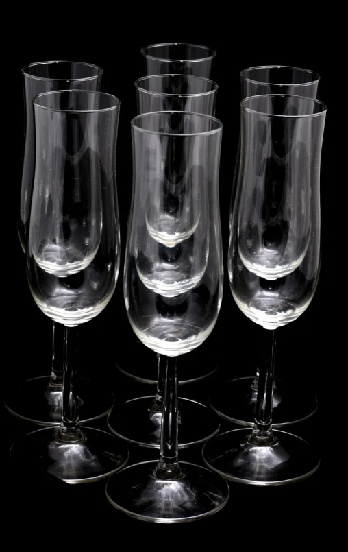 five wine glasses are set on the table together