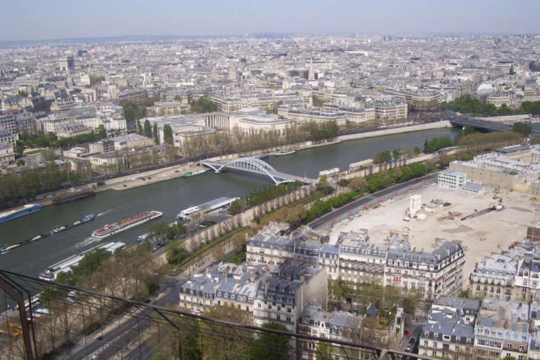 an aerial view of paris in the distance with boats