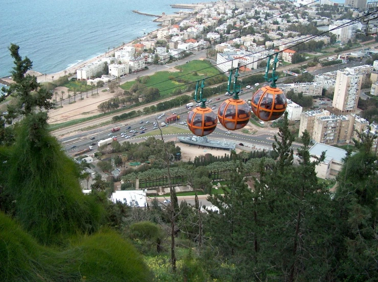 the two gondolas are hanging on the tree tops