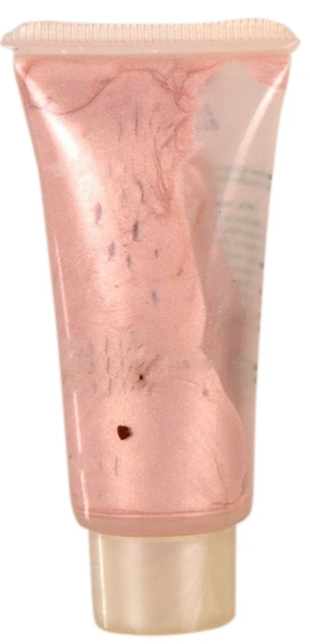 a pink tube on a white surface