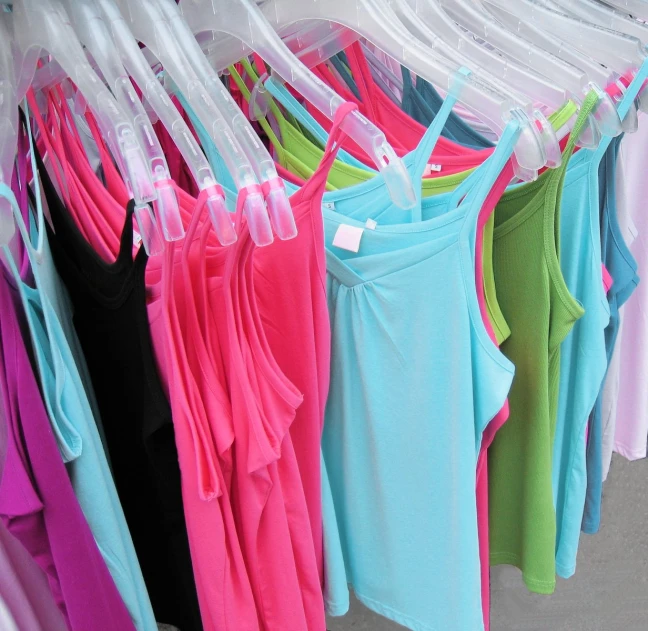 a display case with colorful shirts hanging on clothes pins