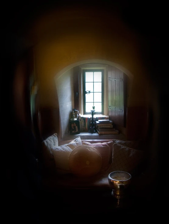 an oval image shows a window and a white sofa