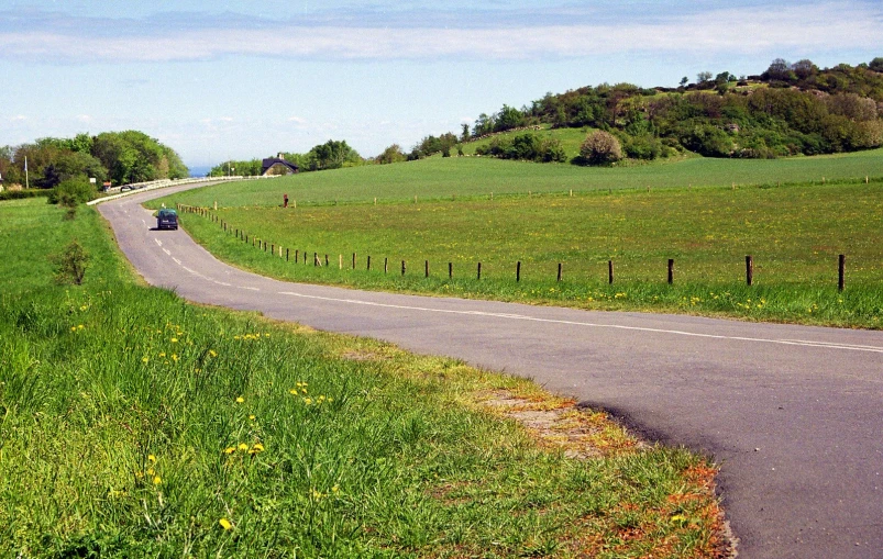 a car is driving down an open road