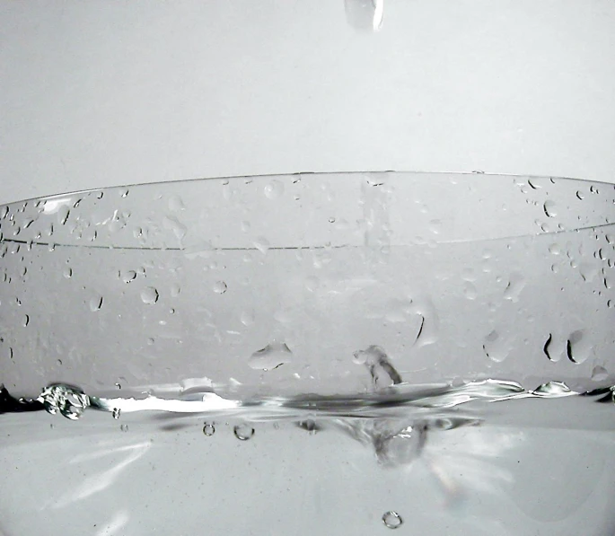 a glass filled with water on top of a table