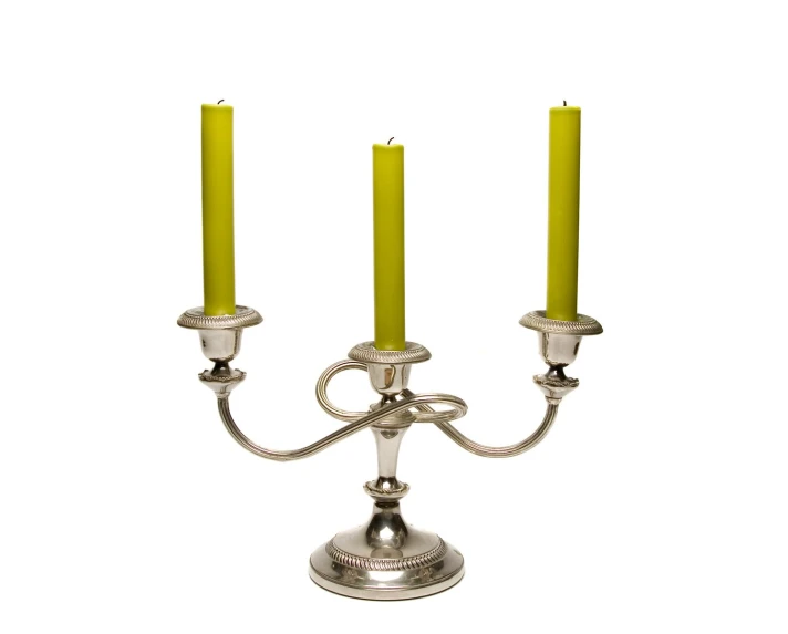 two metal candela with three yellow candles in each