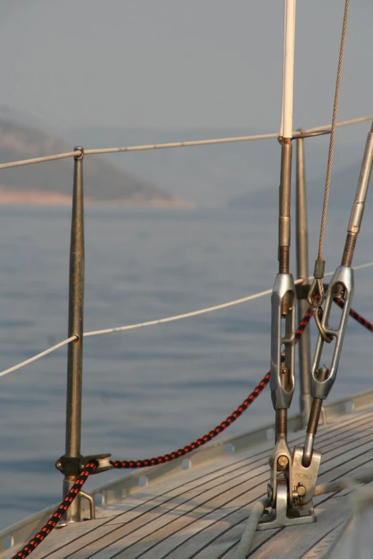 the ropes and handles on the bow of a sail boat