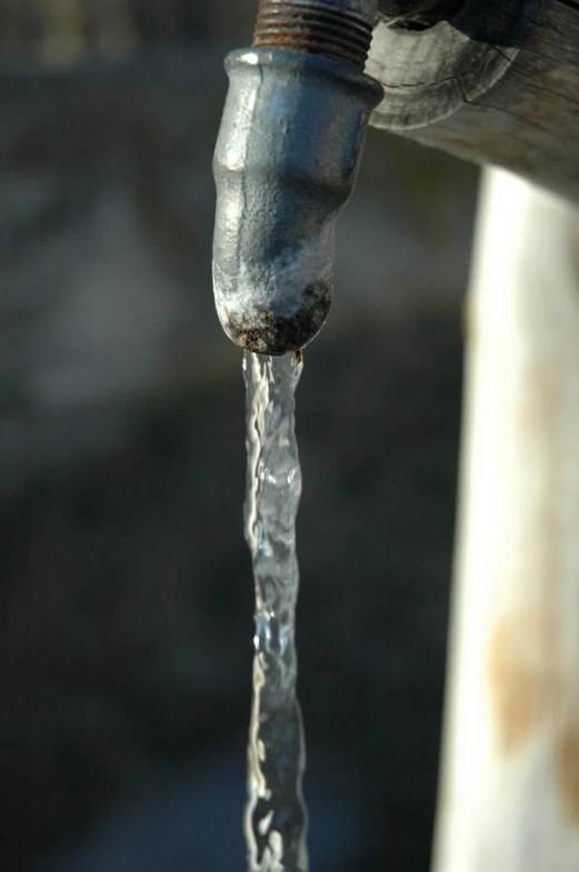 a water faucet connected to the water running out of it