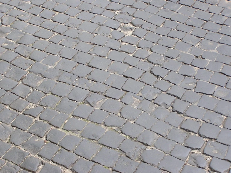 a street is made of grey tile and stone