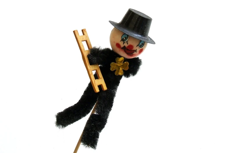 an animal like doll holding a small wooden ladder
