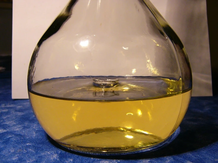 a close up of a liquid in a wine glass on a table