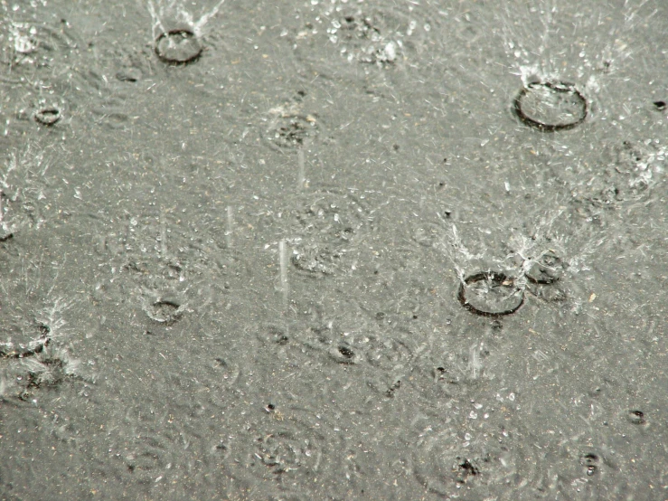 water on the sand and droplets hanging from them