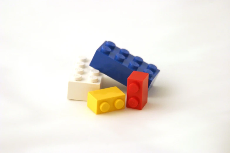 an image of three lego bricks sitting on the ground
