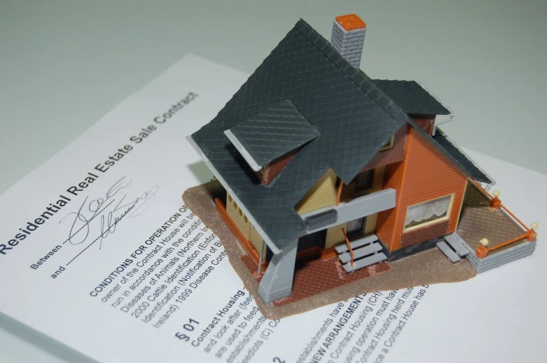 a close up of a home sitting on top of a paper