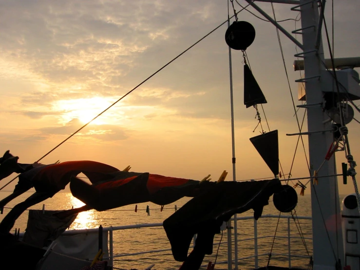 a person is doing a hand stand on the front of a ship