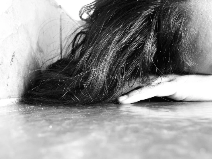 black and white pograph of woman laying down on the ground